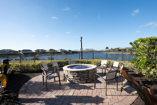 view of patio featuring a water view and a fire pit