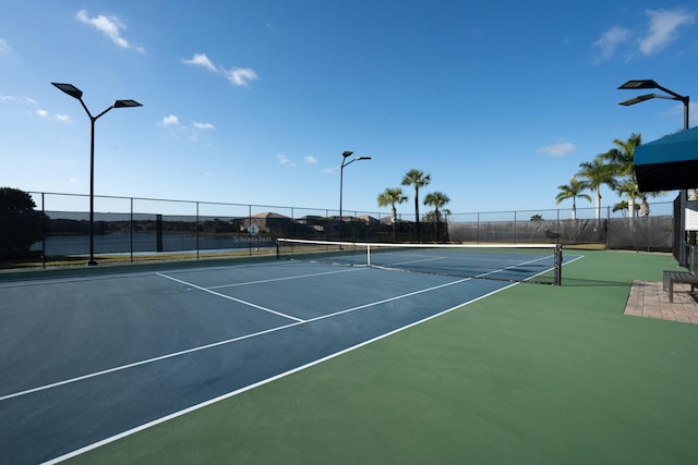 view of tennis court featuring fence