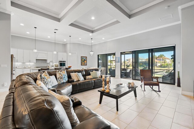 dining space with crown molding, beamed ceiling, coffered ceiling, and a notable chandelier