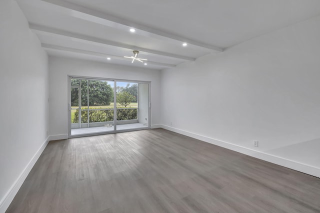 unfurnished room with beamed ceiling, recessed lighting, wood finished floors, and baseboards