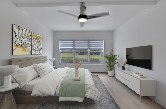 bedroom with light wood-style floors, baseboards, and a ceiling fan