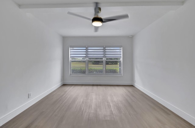 empty room with hardwood / wood-style flooring, ceiling fan, and beam ceiling