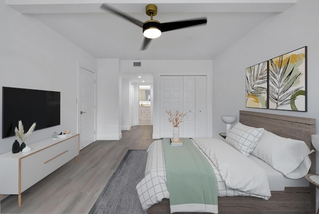 bedroom with ceiling fan, hardwood / wood-style floors, and a closet