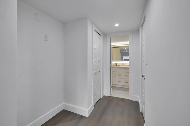 hallway with sink and dark wood-type flooring