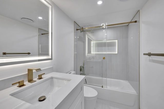 full bathroom with enclosed tub / shower combo, vanity, and toilet