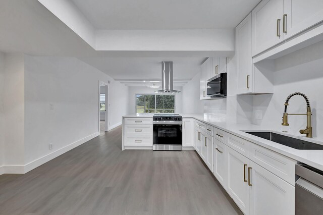 kitchen featuring white cabinetry, appliances with stainless steel finishes, sink, and light hardwood / wood-style floors