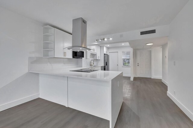 unfurnished living room featuring beamed ceiling, wood-type flooring, and sink