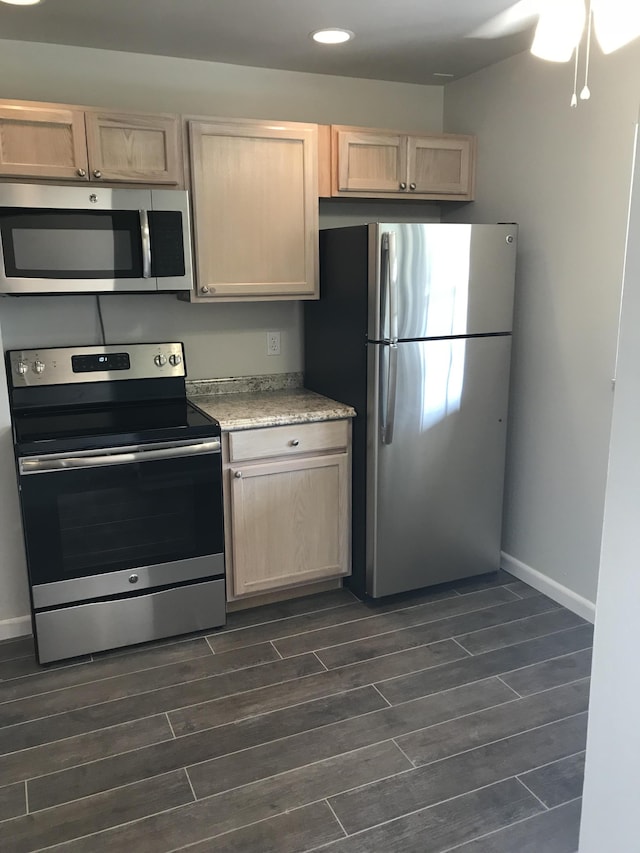 kitchen featuring light brown cabinets, dark hardwood / wood-style flooring, and appliances with stainless steel finishes