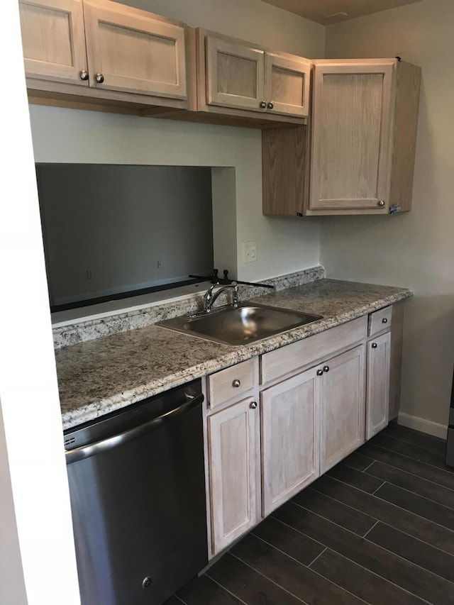 kitchen featuring dishwasher, light brown cabinets, light stone countertops, and sink