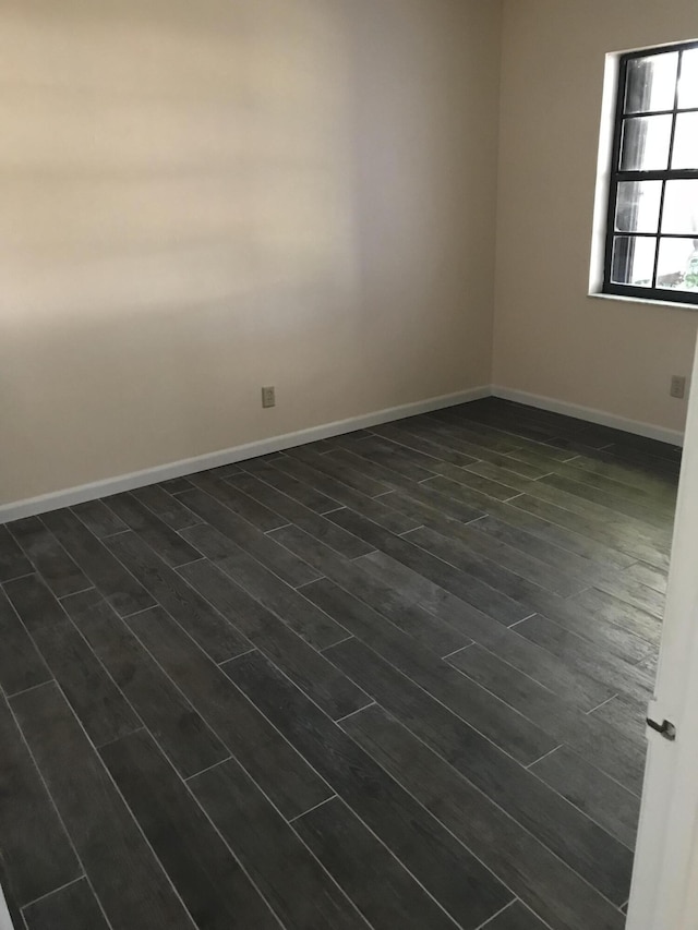 empty room with dark hardwood / wood-style floors