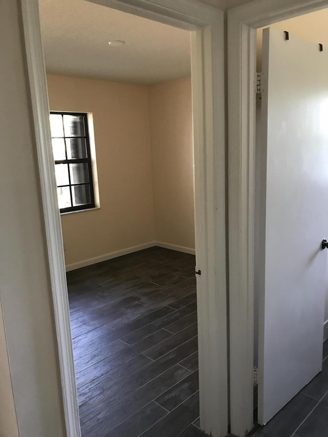 corridor with dark hardwood / wood-style floors