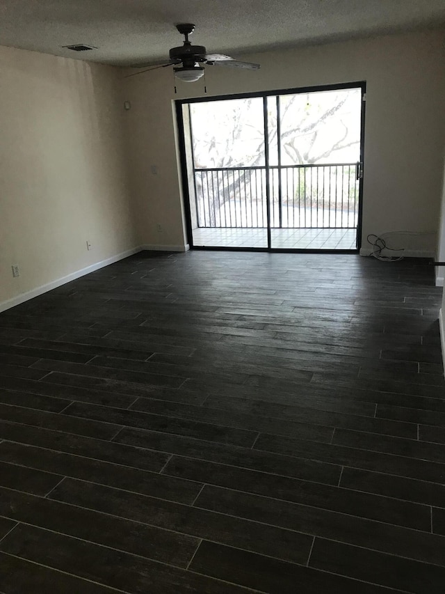 unfurnished room featuring ceiling fan and a textured ceiling