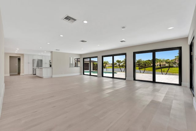 unfurnished living room with light hardwood / wood-style floors