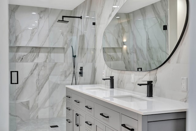 bathroom with a shower with shower door and vanity