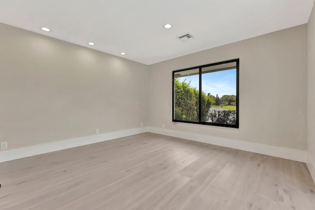 spare room featuring light wood-type flooring