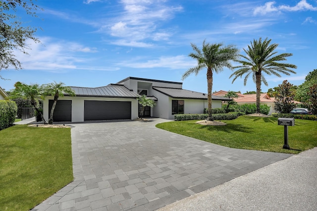 view of front of house with a front yard and a garage