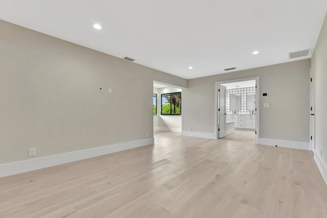 spare room with light hardwood / wood-style flooring