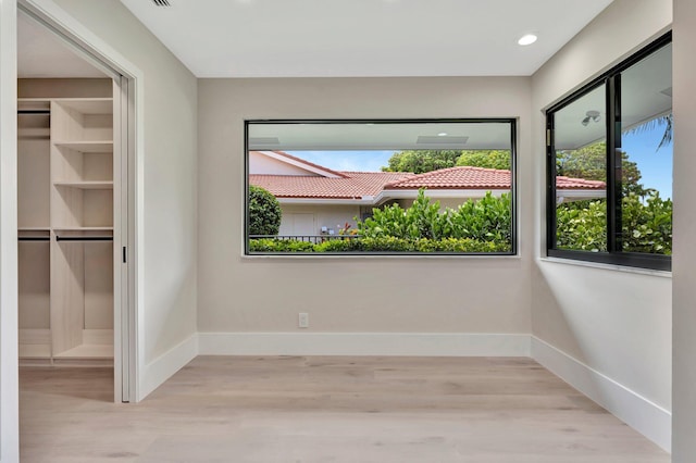 unfurnished room with light hardwood / wood-style flooring