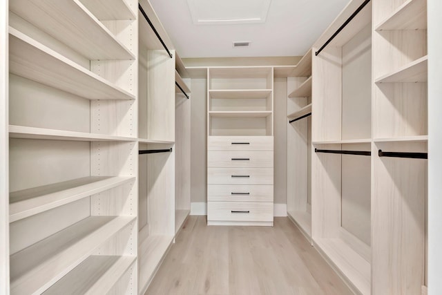 walk in closet with light wood-type flooring