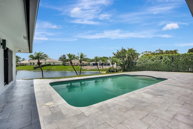 view of pool featuring a water view and a patio