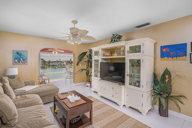 tiled living room with ceiling fan