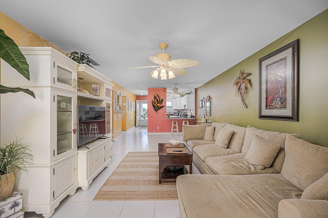 living room featuring ceiling fan and light tile patterned floors