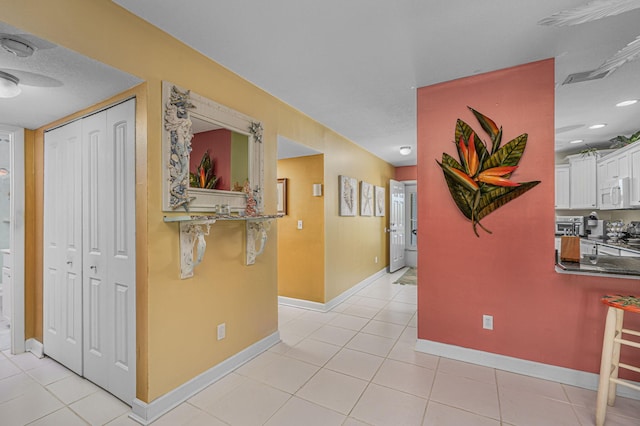 hallway with light tile patterned flooring