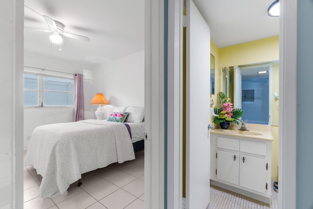 bedroom with ceiling fan, light tile patterned flooring, and sink