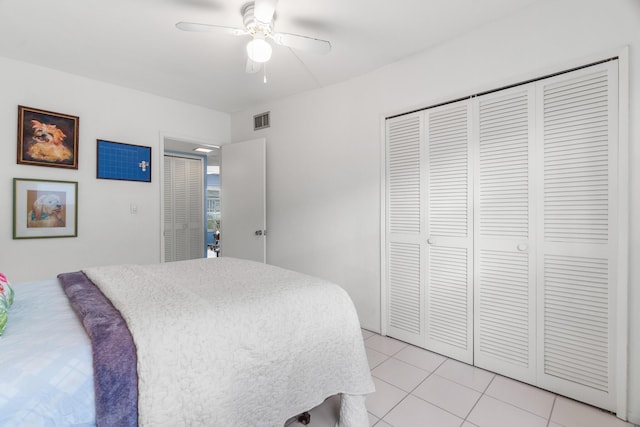 tiled bedroom with ceiling fan