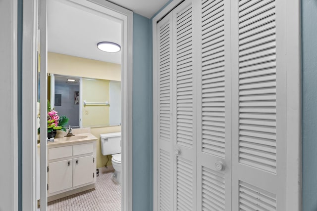 bathroom featuring tile patterned flooring, vanity, and toilet