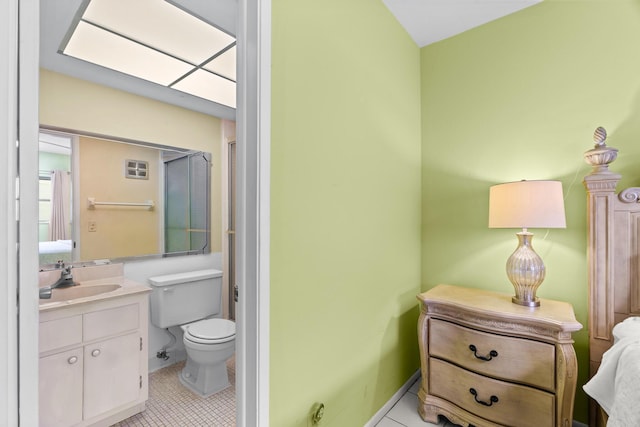 bathroom with tile patterned flooring, vanity, and toilet