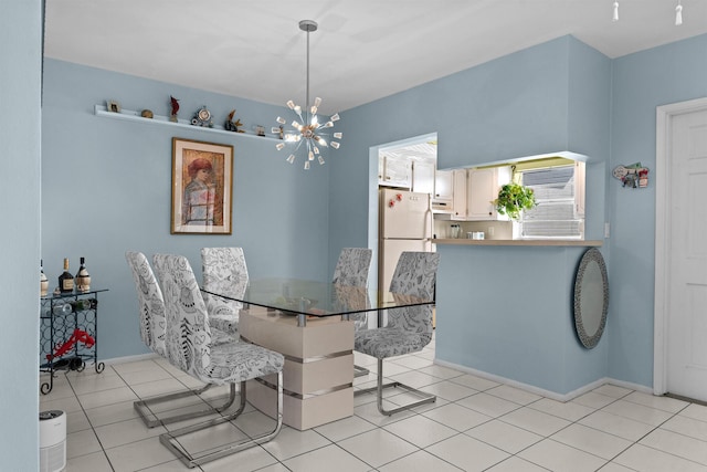 dining area with light tile patterned floors and a chandelier