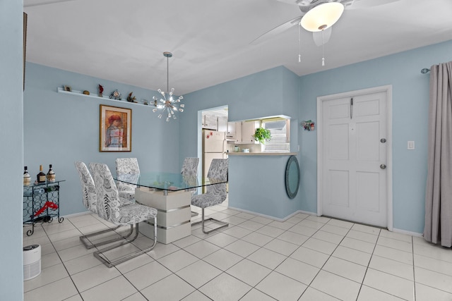 tiled dining room featuring ceiling fan with notable chandelier