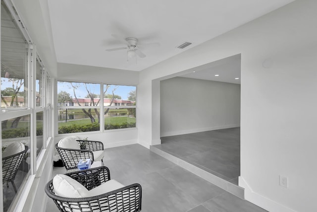 sunroom / solarium featuring ceiling fan