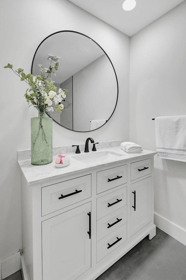 bathroom with vanity and concrete flooring