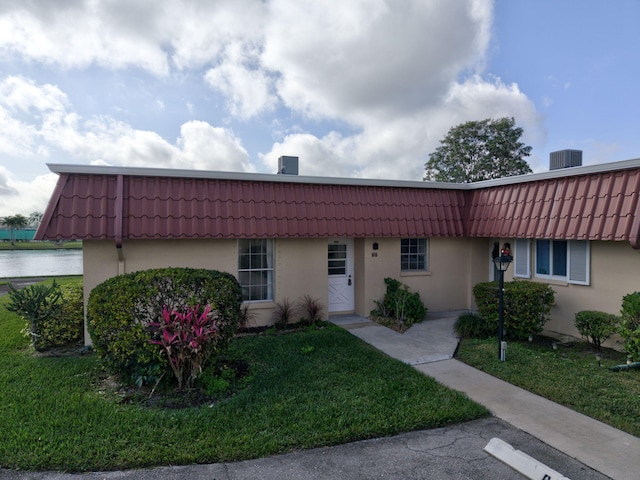 single story home with central air condition unit and a front yard