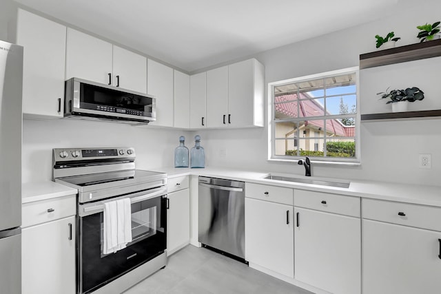 kitchen featuring sink, white cabinetry, and stainless steel appliances