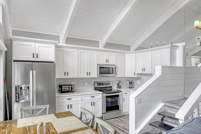 kitchen with stainless steel appliances, white cabinets, light countertops, beam ceiling, and decorative backsplash