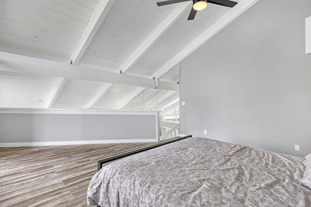 bedroom with hardwood / wood-style floors, vaulted ceiling with beams, and ceiling fan