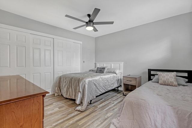 bedroom with ceiling fan, a closet, and light hardwood / wood-style floors