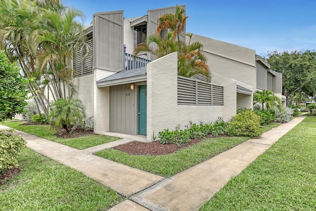 view of property exterior featuring a yard and stucco siding