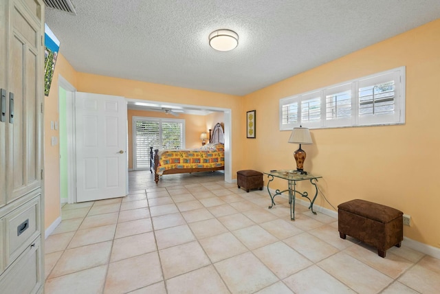 interior space with light tile patterned flooring and a textured ceiling