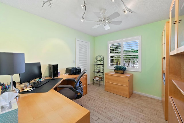 office area featuring ceiling fan, light hardwood / wood-style floors, and a textured ceiling