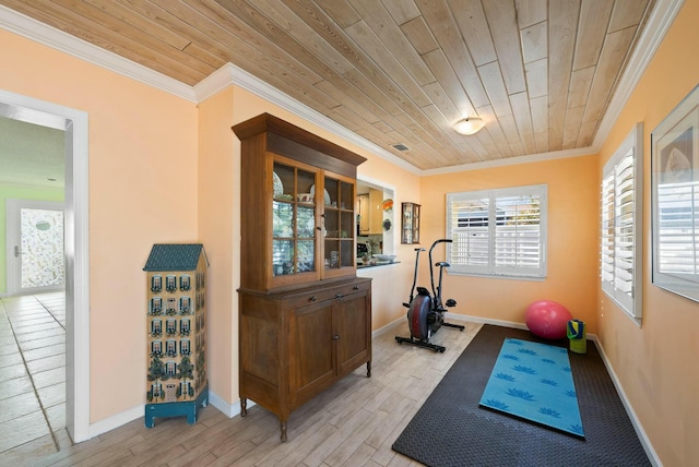 workout room featuring crown molding, wood ceiling, and light hardwood / wood-style floors