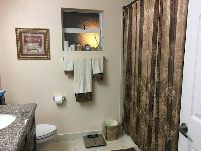 bathroom with tile patterned flooring, vanity, and toilet