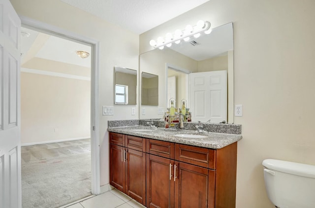 901 SW 15th St, Deerfield Beach, FL 33441 - bathroom featuring double vanity, toilet, tile patterned flooring, and baseboards