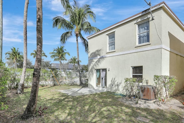 901 SW 15th St, Deerfield Beach, FL 33441 - back of property featuring central AC unit, stucco siding, and a patio