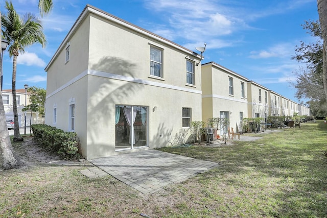 901 SW 15th St, Deerfield Beach, FL 33441 - rear view of house with stucco siding, a patio area, a lawn, and a residential view