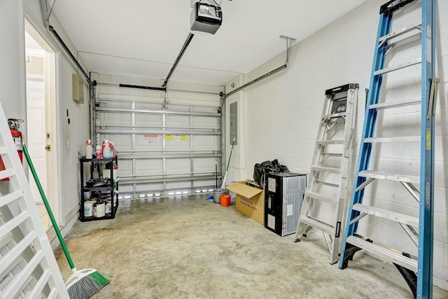 901 SW 15th St, Deerfield Beach, FL 33441 - garage featuring a garage door opener, concrete block wall, and electric panel