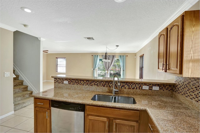 901 SW 15th St, Deerfield Beach, FL 33441 - kitchen featuring dishwasher, a sink, brown cabinetry, decorative backsplash, and a textured ceiling